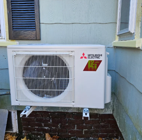 Mitsubishi outdoor heat pump secured on a wall bracket