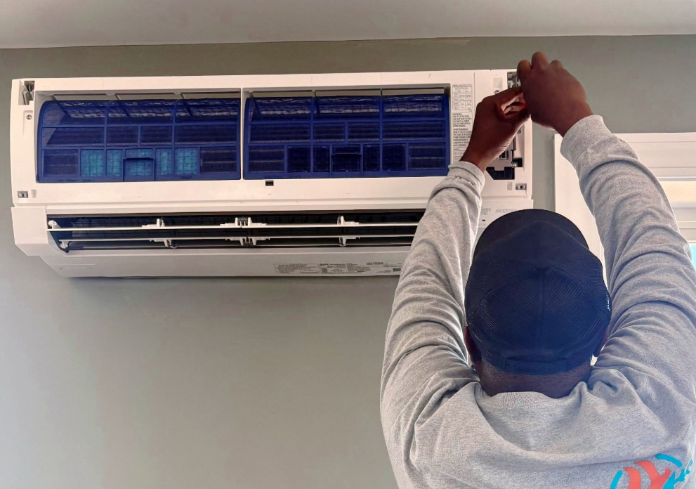 JDK HVAC technician servicing a wall-mounted mini-split
