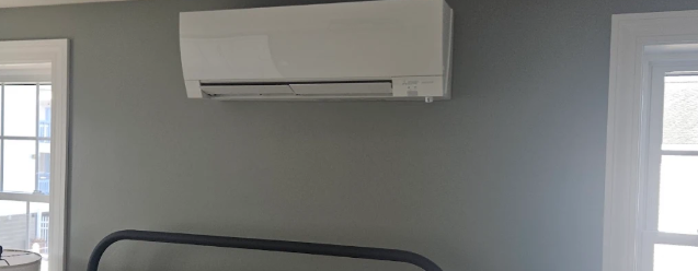 Mini-split installed neatly on a gray bedroom wall